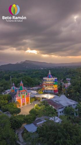 a group of buildings in a city with the sunset at Mirador del Castillo in Tenexcalco