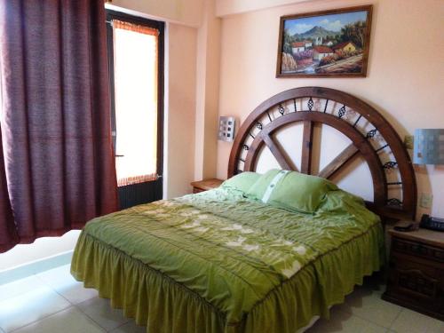 a bedroom with a large bed and a window at Hotel Imperial Jojutla in Jojutla de Juárez
