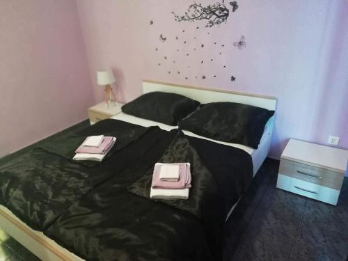a bedroom with a bed with two towels on it at Apartman BubaMara in Sveti Juraj