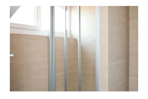 a shower with a glass door in a bathroom at LOFT Centro Ribadesella in Ribadesella