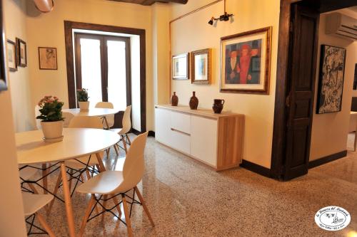 a dining room with a table and chairs at La Dimora del Musicante HomeGallery in Viggiano