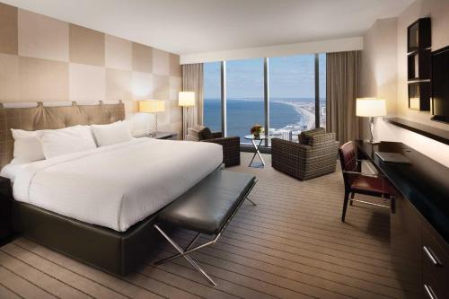 a hotel room with a large bed and a large window at Ocean Casino Resort in Atlantic City