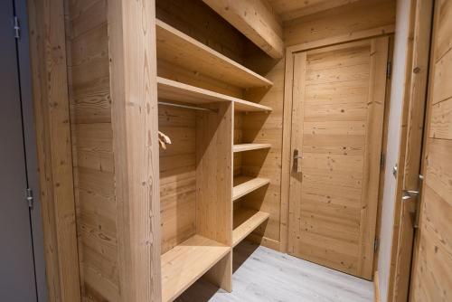 a wooden sauna with wooden shelves at Hôtel Flor'Alpes in La Giettaz