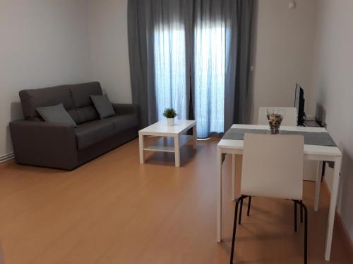 a living room with a couch and a table at Apartamentos Begastri in Cehegín