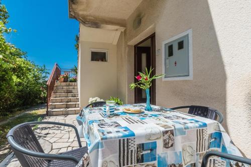 a table with a blue and white table cloth at House Gloria in Crikvenica