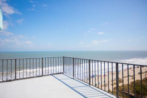 a balcony with a view of the beach at Tropical Seas Hotel in Myrtle Beach
