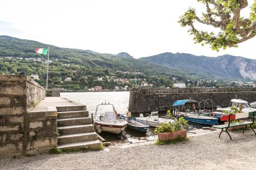a group of boats docked next to the water at Belvedere in Stresa