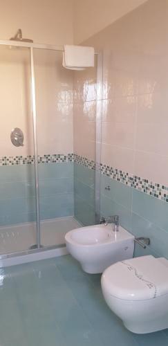 a bathroom with a toilet and a sink and a shower at Stella Marina Agropoli in Agropoli