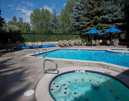 a swimming pool with a hot tub in a yard at Falcon Point in Avon