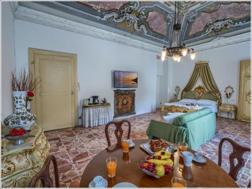 a living room with a table and a couch at VILLA VINICIA, pool, jacuzzi, airco in Domaso