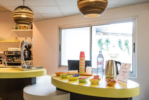 a counter with bowls of food on a table at ibis styles Dax Centre in Dax