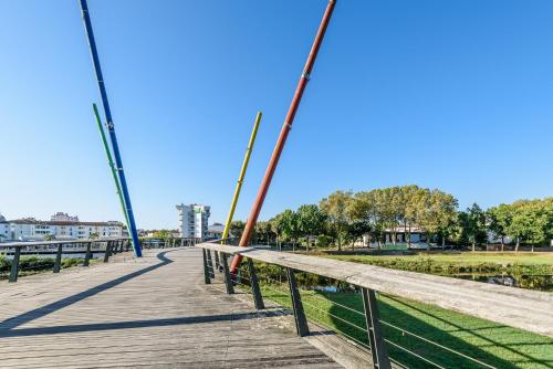 a wooden bridge over a body of water at ibis styles Dax Centre in Dax