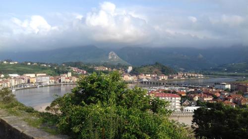 a view of a city and a river with a mountain at Hotel Brisas del Sella in Ribadesella