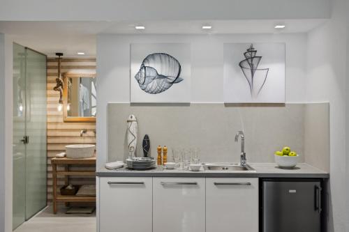Una cocina con gabinetes blancos y un fregadero. en Villa Elvina, en Kissamos