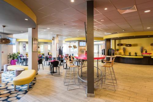 a restaurant with tables and chairs in a cafeteria at Miradour in Dax