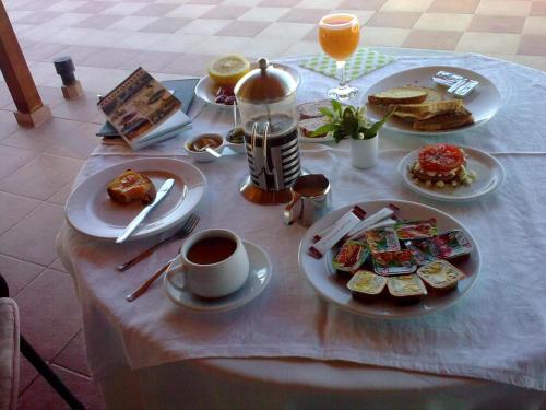 a table with plates of food and a cup of coffee at La Petite Planete in Mykines