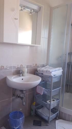 a bathroom with a sink and a mirror at Apartments Adri, Parking in the yard in Rovinj