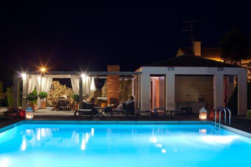a swimming pool in front of a house at night at Quinta do Monteverde in Viana do Castelo