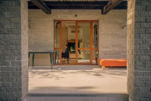 a person sitting at a table in a building at Brīvdienu māja Sauleskrasti in Mērsrags