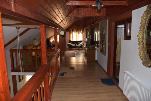 a hallway of a house with wooden floors and ceilings at Cabana Steaua Nordului 2 in Vînători