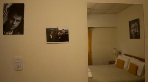 a bedroom with two pictures on the wall at Hotel de Cine Las Golondrinas in Villa Gesell
