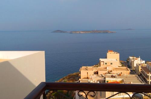 a view of the ocean from the balcony of a building at Vaporia in Ermoupoli