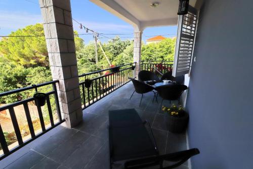 a balcony with a table and chairs and a view at Apartment Marjana Prižba in Prizba