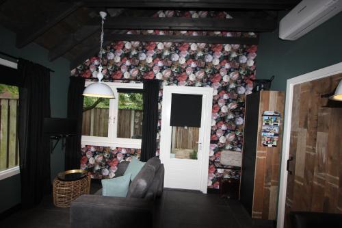 a living room with a wall covered in flowers at B & B Chawe in Enschede