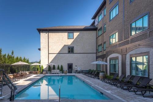 a swimming pool in front of a building at Village Hotel on Biltmore Estate in Asheville