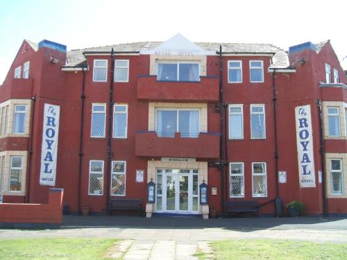 a red brick building with white signs on it at Royal Hotel in Blackpool