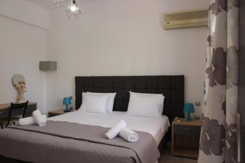 a bedroom with a bed with white towels on it at Platoni Elite in Ialyssos