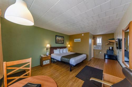 a hotel room with a bed and a tv at Marlane Motel in Wildwood
