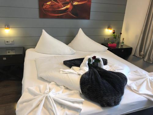 a bed with white sheets and towels on it at Hotel Vogelweiderhof in Salzburg