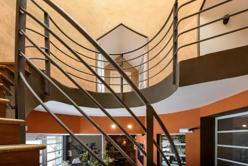 a spiral staircase in a building with a lobby at Hotel La Posada De Alameda in Alameda del Valle