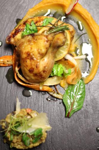 a plate of food with chicken and vegetables on a table at Apartmány Ztracená in Roudnice nad Labem