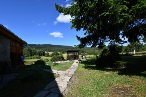 a walkway leading to a building in a field at Chalupa Chlum Míša in Volary