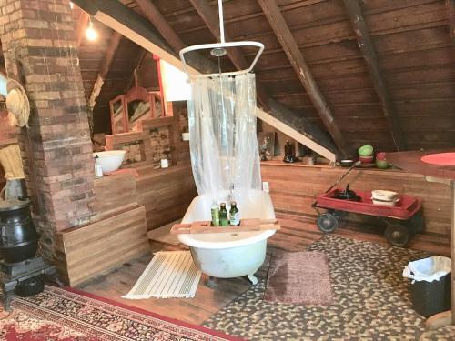 a bathroom with a tub and a toilet in a room at Aaron House of Niagara Falls in Niagara Falls