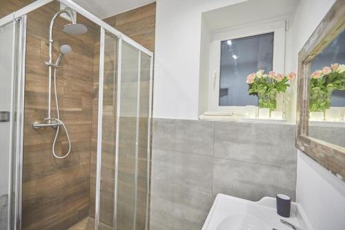a bathroom with a shower and a sink at Saska Kępa Apartamenty in Warsaw