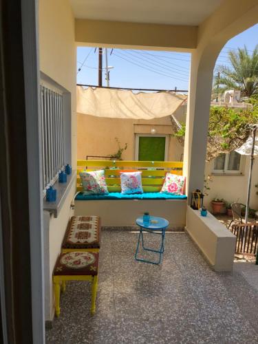 a porch with a couch and a table on a balcony at Lucky 4 in Paralimni