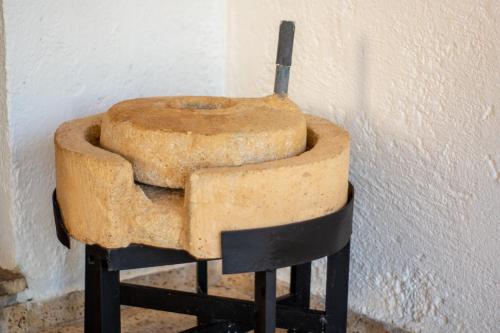 an old chair sitting next to a wall at Elias Maro House in Avdou