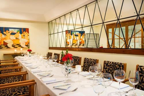 a long table in a room with wine glasses at Airways Hotel in Port Moresby