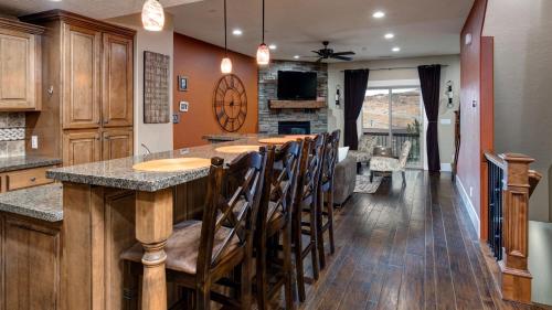 a kitchen with a bar with wooden stools at Park'S Edge 844 Townhouse in Keetley Junction