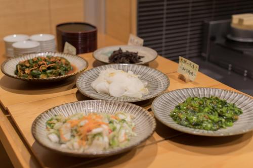 a group of plates of food on a counter at Hana Beppu in Beppu