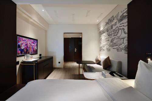 a hotel room with a bed and a television at CitiGO Hotel Nanshan Shenzhen in Shenzhen