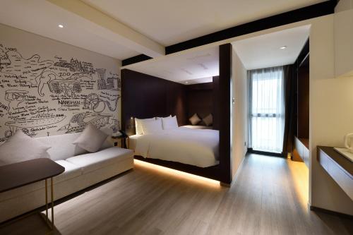 a bedroom with a bed and a wall with a mural at CitiGO Hotel Nanshan Shenzhen in Shenzhen