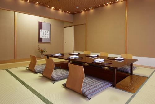 a conference room with a wooden table and chairs at Grand Prince Hotel Shin Takanawa in Tokyo