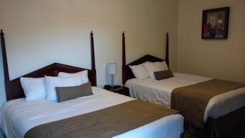 Postel nebo postele na pokoji v ubytování Cattlemen Motel
