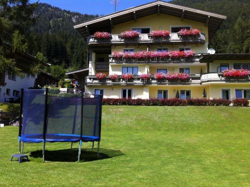 a building with a blue volleyball net in front of it at Haus Lechner Apartments in Sankt Jakob in Haus