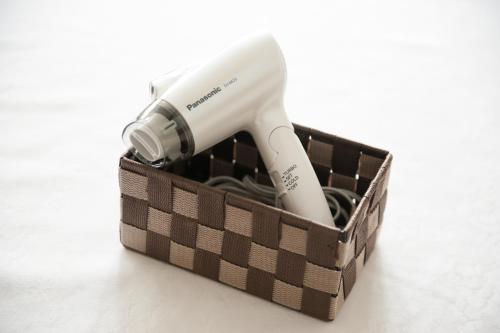 a electric hair dryer in a box on a table at Hotel Yassa in Mihara