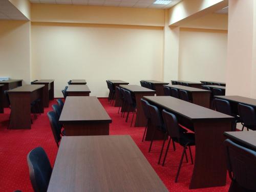 an empty room with tables and chairs in it at Hotel Magnus Galati in Galaţi